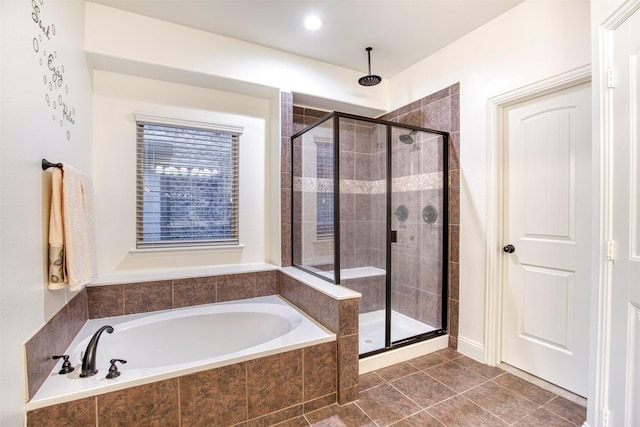 bathroom featuring a stall shower, a garden tub, and tile patterned floors