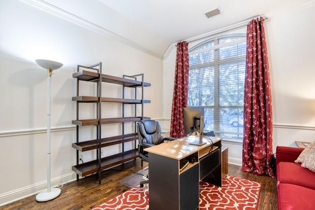1005 Brendan Dr, Little Elm, TX 75068 - home office with dark wood-style floors, ornamental molding, and baseboards