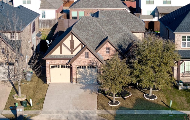 view of front facade with a residential view, roof with shingles, driveway, and brick siding