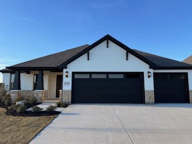 view of front of home with a garage, stone siding, driveway, and a porch