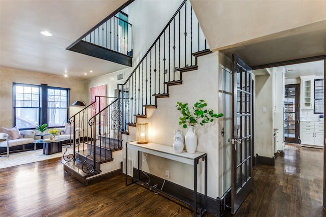 stairs with recessed lighting, baseboards, and wood finished floors