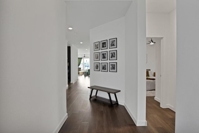 hall with baseboards, dark wood-style flooring, and recessed lighting