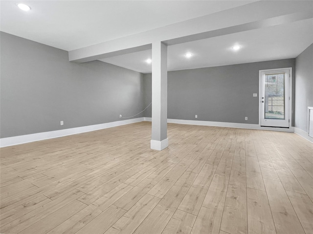 below grade area with light wood finished floors, baseboards, and recessed lighting