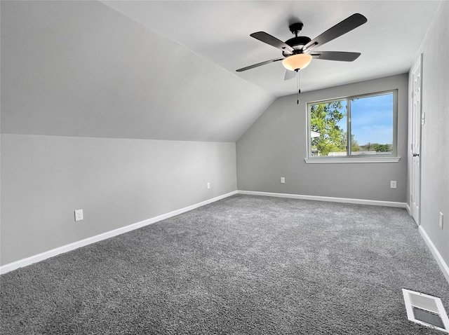 additional living space with baseboards, visible vents, lofted ceiling, ceiling fan, and carpet flooring