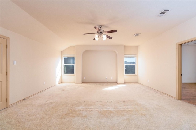 unfurnished room featuring light carpet, visible vents, and a ceiling fan