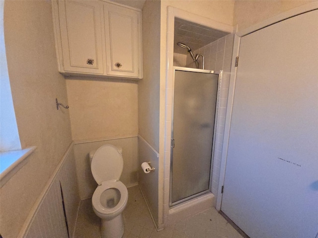 full bath featuring a shower stall and toilet