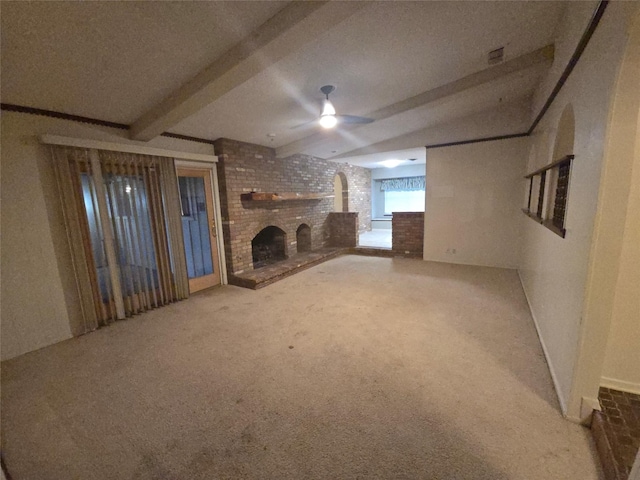 unfurnished living room featuring ceiling fan, carpet floors, a fireplace, visible vents, and beamed ceiling