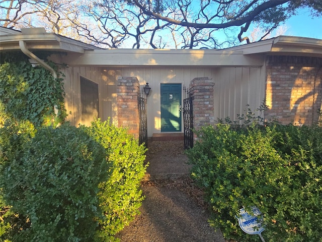 view of exterior entry with brick siding