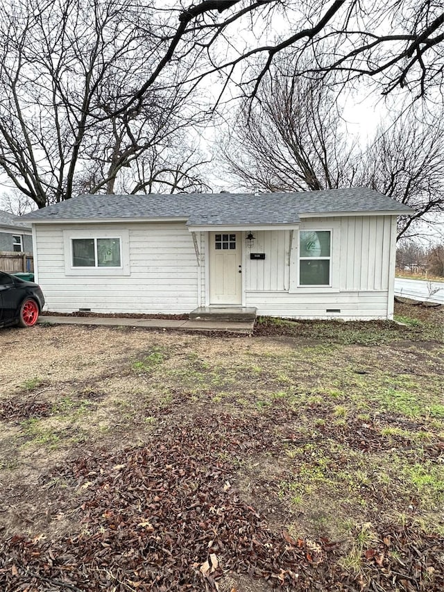 view of front of house featuring crawl space, board and batten siding, and roof with shingles