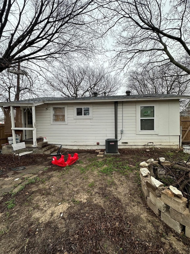 rear view of house with central AC unit