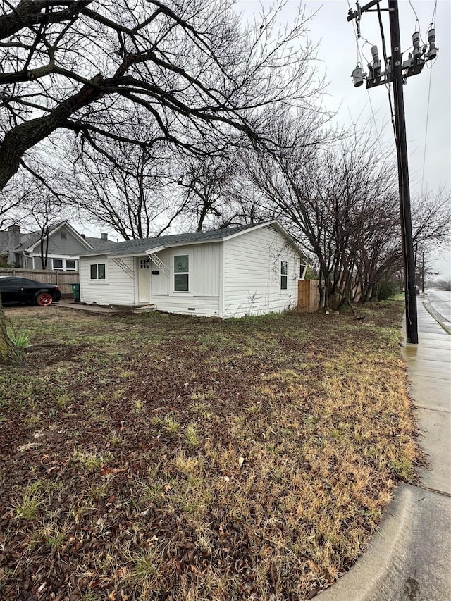 view of side of home with fence