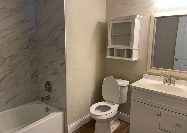 bathroom with shower / bath combination, a textured wall, vanity, and baseboards