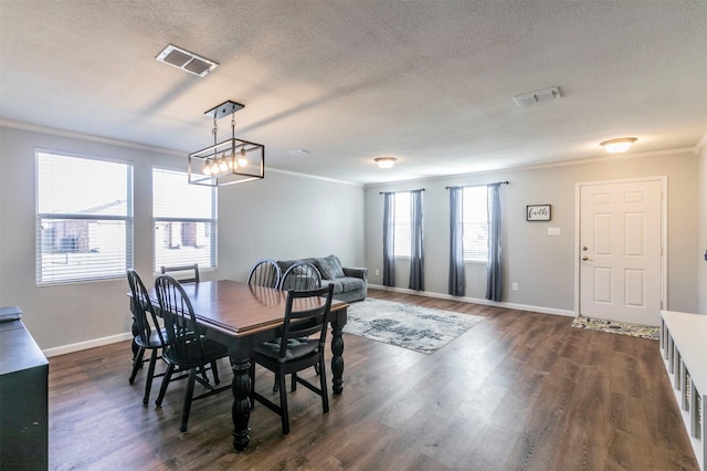 dining area with dark wood-style floors, visible vents, crown molding, and a textured ceiling