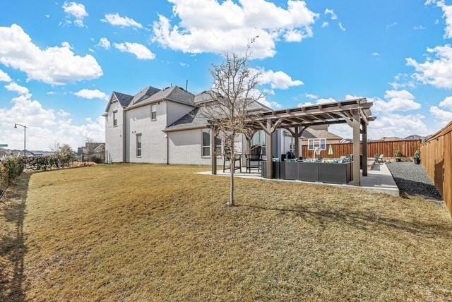 back of house featuring a yard, a fenced backyard, a pergola, and a patio