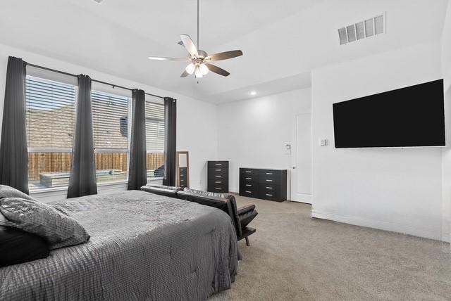 bedroom featuring carpet floors, ceiling fan, and visible vents