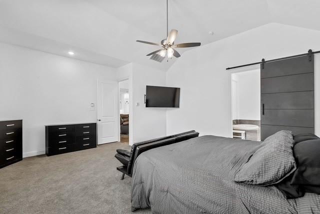 bedroom with a barn door, vaulted ceiling, a ceiling fan, and light colored carpet