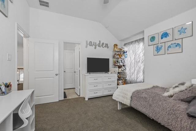 bedroom featuring lofted ceiling, visible vents, dark colored carpet, and a ceiling fan