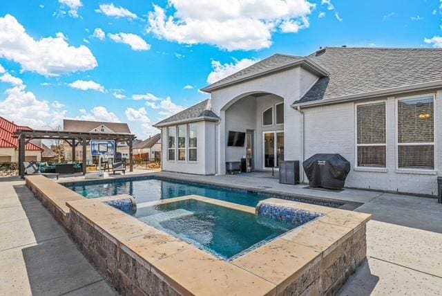 view of pool with a pergola, grilling area, a patio, and an in ground hot tub