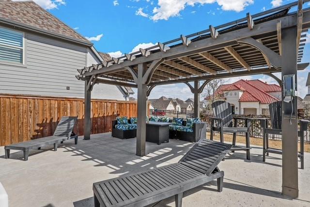 view of patio featuring fence, an outdoor living space, and a pergola