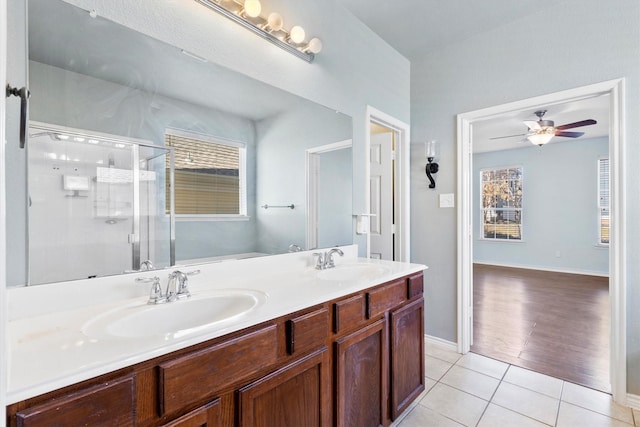 full bathroom with plenty of natural light, a sink, a shower stall, and tile patterned floors