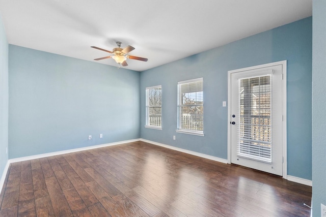 spare room with ceiling fan, baseboards, and wood finished floors