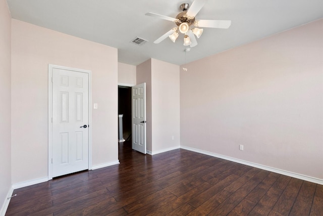 unfurnished bedroom featuring hardwood / wood-style flooring, baseboards, visible vents, and a ceiling fan