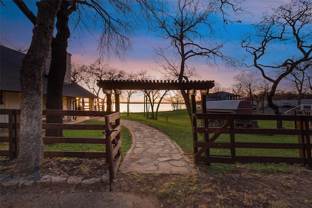 gate at dusk with a yard and fence