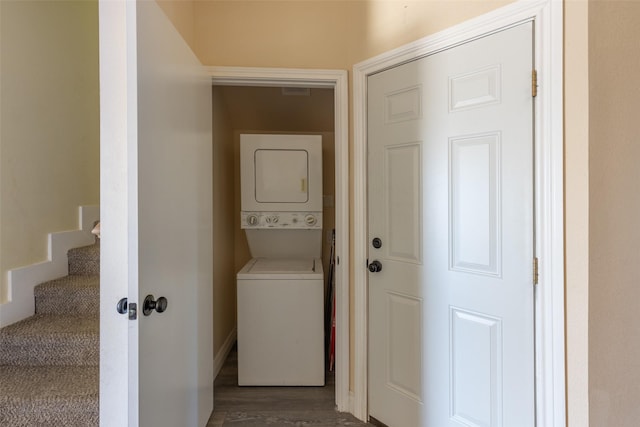 washroom with stacked washer / drying machine and laundry area