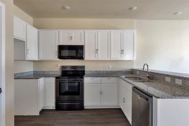 kitchen with stone counters, dark wood-style flooring, a sink, white cabinets, and black appliances