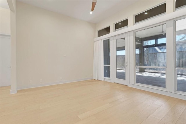 empty room featuring light wood-style flooring, baseboards, a ceiling fan, and recessed lighting