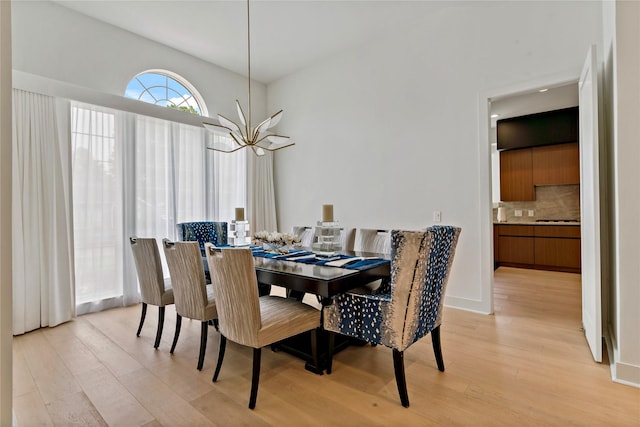 dining space with an inviting chandelier and light wood-style flooring