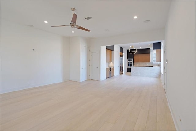 unfurnished living room featuring ceiling fan, recessed lighting, visible vents, baseboards, and light wood finished floors