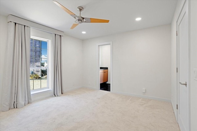 bedroom with ceiling fan, ensuite bathroom, recessed lighting, light colored carpet, and baseboards