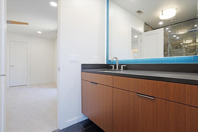 bathroom featuring a stall shower, vanity, visible vents, and tile patterned floors