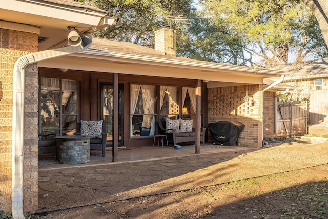 exterior space with brick siding and a chimney