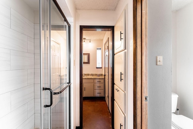 hallway with a textured ceiling