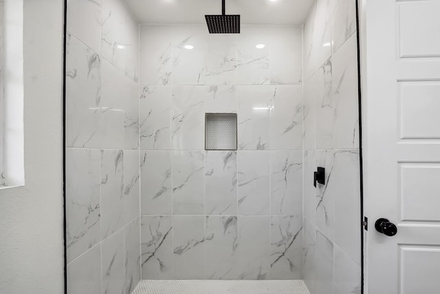 bathroom with a marble finish shower