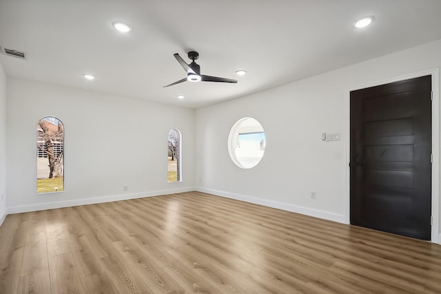 empty room with a ceiling fan, recessed lighting, visible vents, and light wood-style floors