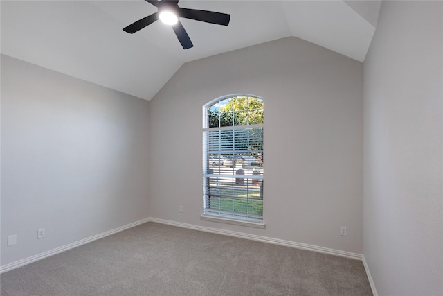 empty room with carpet, baseboards, vaulted ceiling, and a ceiling fan