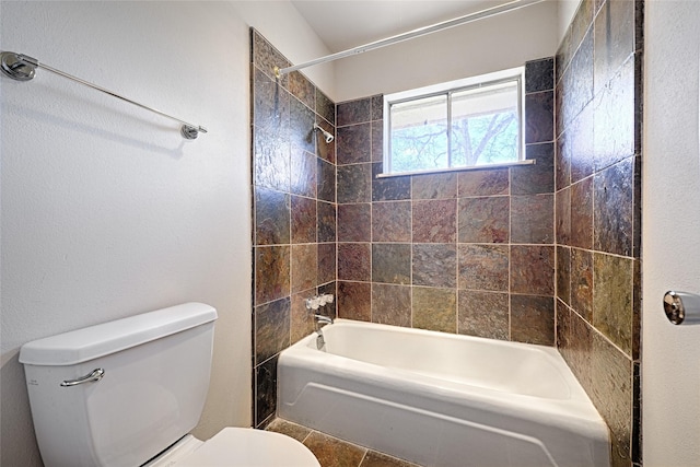 bathroom with toilet and bathtub / shower combination