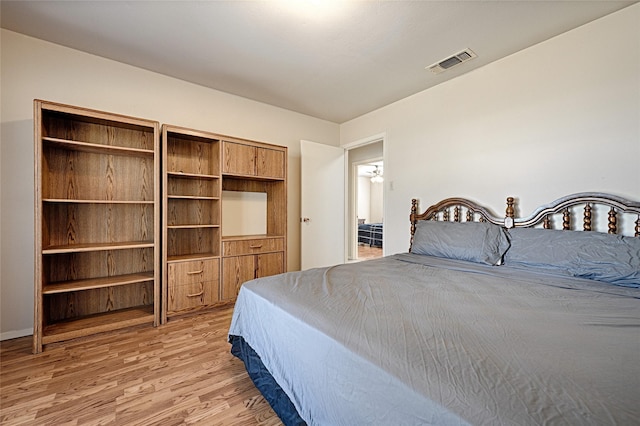 bedroom featuring light wood finished floors and visible vents