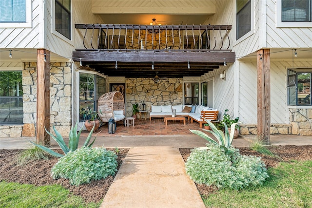 3113 Rock Creek Rd, Mineral Wells, TX 76067 - doorway to property featuring a patio area, stone siding, outdoor lounge area, and a balcony