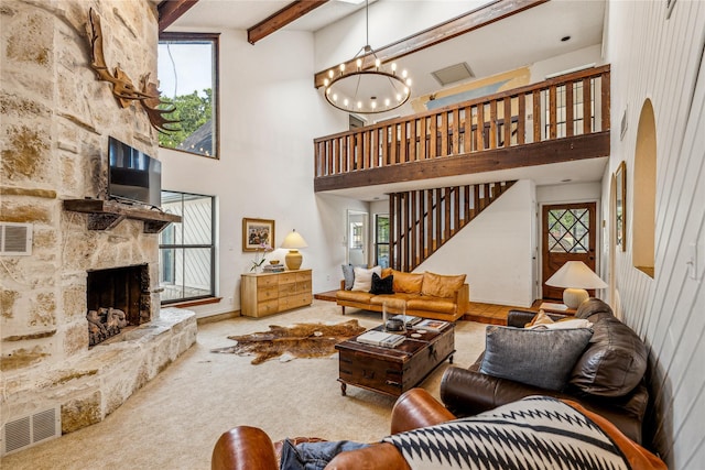 3113 Rock Creek Rd, Mineral Wells, TX 76067 - carpeted living area featuring visible vents, a fireplace, stairway, and an inviting chandelier