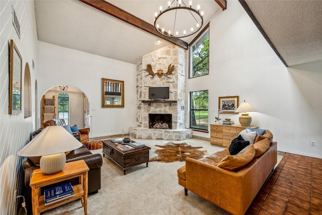 3113 Rock Creek Rd, Mineral Wells, TX 76067 - living room featuring arched walkways, a fireplace, high vaulted ceiling, beamed ceiling, and baseboards