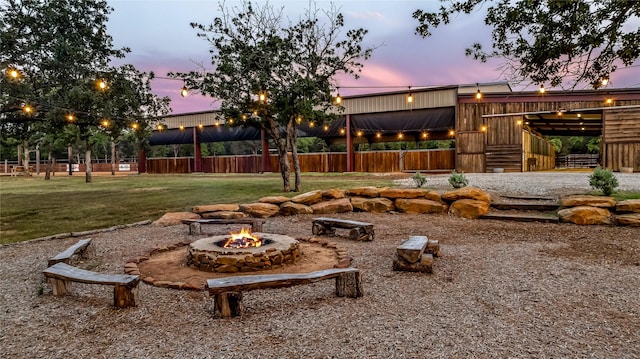 view of yard with an outdoor fire pit and an exterior structure