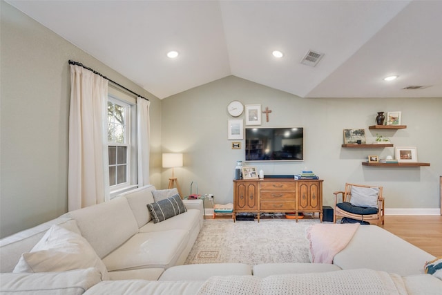 living area featuring recessed lighting, visible vents, vaulted ceiling, and wood finished floors