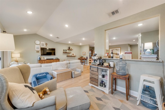 living area with lofted ceiling, baseboards, visible vents, and recessed lighting