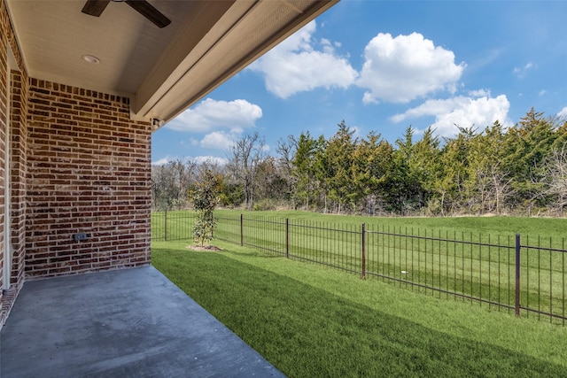 view of yard featuring a fenced backyard, ceiling fan, and a patio