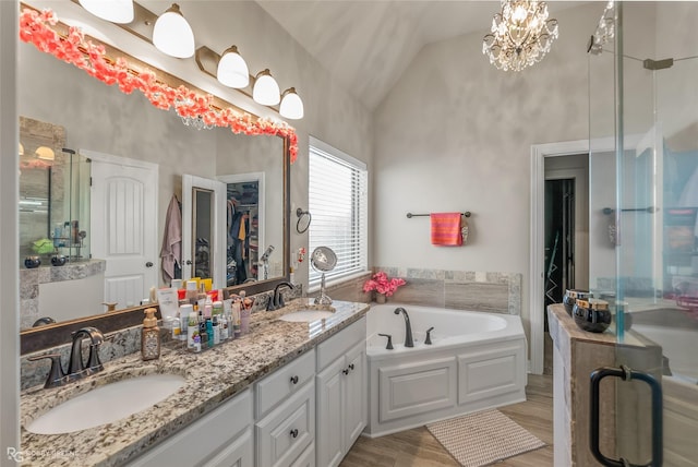 full bath with a stall shower, a sink, lofted ceiling, and a bath