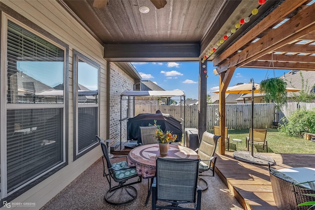 view of patio / terrace featuring outdoor dining area, fence, a wooden deck, and a pergola